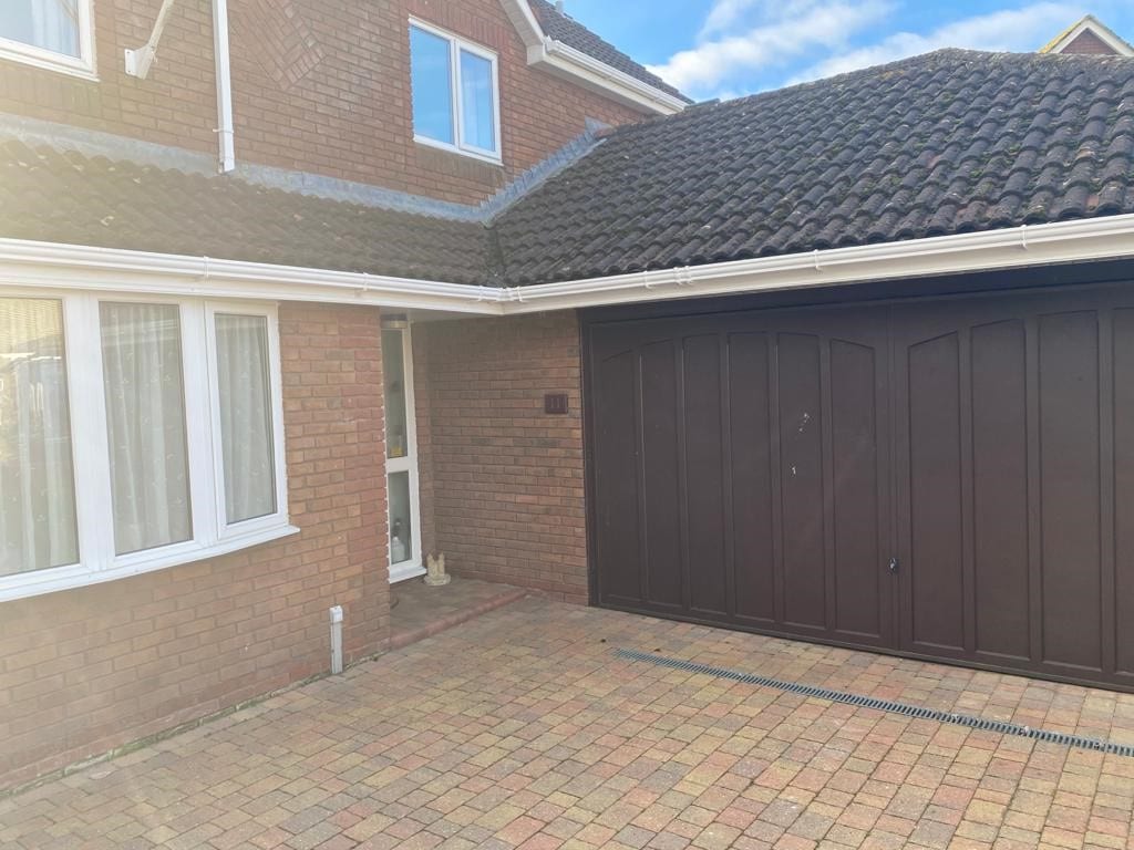 Front of house with up and over garage doors on show